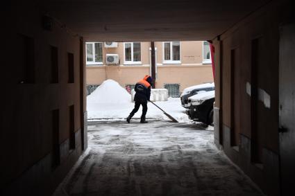 Москва.  Дворник во время уборки снега  в Скатертном переулке.