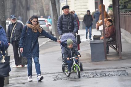 Москва.  Женщина с ребенком на улице города.