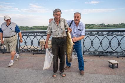 Астрахань. Корреспондент `Комсомольской правды` Александр Гамов с одним из рыбаков на центральной набережной города.