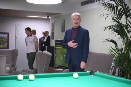 Москва.  Мэр Москвы Сергей Собянин  во время  игры в бильярд с посетителями  нового социального  центра `Мой социальный центр` для пенсионеров  на улице Сергия Радонежского.