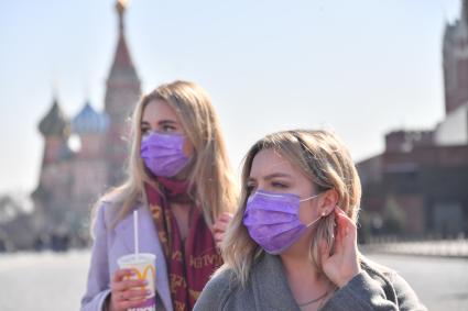 Москва.   Девушки в медицинских масках на Красной площади.