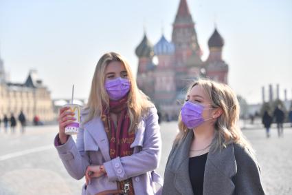 Москва.   Девушки в медицинских масках на Красной площади.