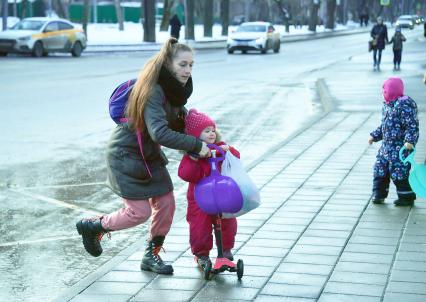 Москва. Женщина с детьми переходит улицу.