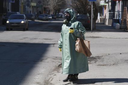 Барнаул. Женщина в плаще ОЗК и противогазе на улице.