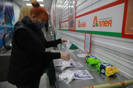 Красноярск. Женщина в медицинской маске в продуктовом магазине.