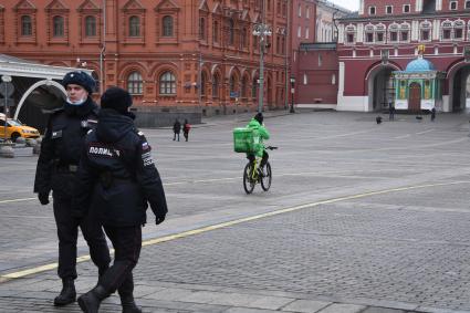 Москва. Сотрудники сервиса по доставке еды  на Манежной площади.