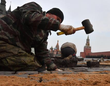 Москва. Рабочий во время замены брусчатки на Красной площади.