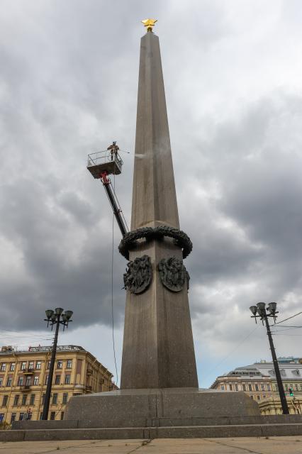 Санкт-Петербург. Сотрудник коммунальной службы моет  обелиск `Городу-герою Ленинграду` на площади Восстания.