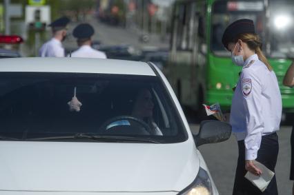 Екатеринбург. Сотрудники ГИБДД вручают водителю светоотражающие значки  наклейки с символикой 75-й годовщины Победы, накануне Дня Победы