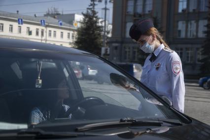 Екатеринбург. Сотрудники ГИБДД вручают водителю светоотражающие значки  наклейки с символикой 75-й годовщины Победы, накануне Дня Победы