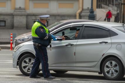Санкт-Петербург.  Сотрудник ДПС во время проверки документа у водителя.