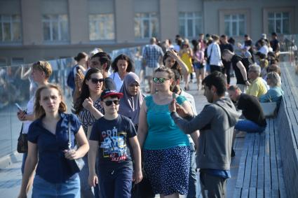 Москва. Отдыхающие  на  Парящем мосту парка Зарядье.