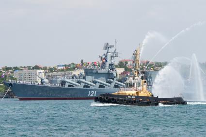 Севастополь. Ракетный крейсер  `Москва`  и рейдовый буксир во время военно-морского парада в честь Дня ВМФ России.