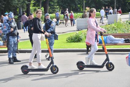 Москва.  Девушки на самокате.