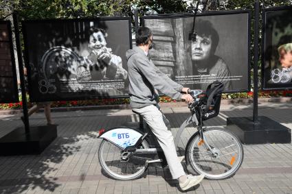 Москва.  Прохожие на открытии фотовыставки, посвященной 85-летию  Олега Табакова на Чистопрудном бульваре.