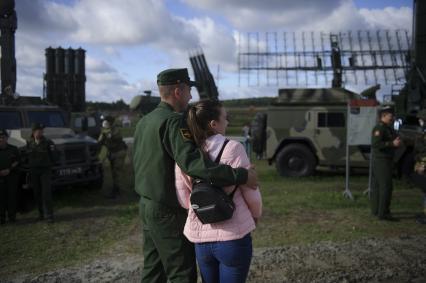 Екатеринбург. Свердловский танковый полигон. Празднование дня танкиста. Военнослужащий с девушкой на выставке вооружения