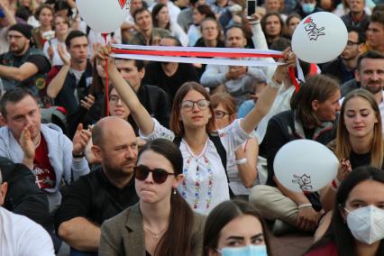 Минск. Девушка дежит ленты в цветах флага Белорусской народной Республики на площади Независимости, где проходит митинг против результатов выборов президента Белоруссии. На площади расположены здания правительства и ЦИК.