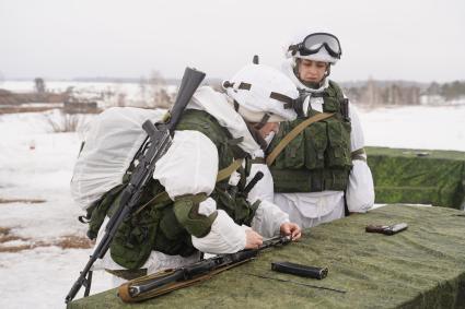 Самарская область. Военнослужащая бригады специального назначения ЦВО собирает автомат во время занятий по боевой подготовке.