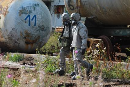 г.Усолье-Сибирское. Военнослужащие войск радиационной, химической и биологической защиты (РХБЗ) РФ после взятия проб из емкости с токсичными отходами на территории закрытого предприятия `Усольехимпром`.