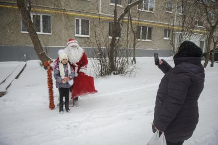 Екатеринбург. Благотворительный фонд \'Дорогами добра\'. Дамир Юсупов - Герой России, пилот авиакомпании \'Уральские авиалинии\' посадивший пассажирский самолет Airbus A321 в кукурузном поле, в костюме деда мороза, поздравляет ребенка с новым годом.