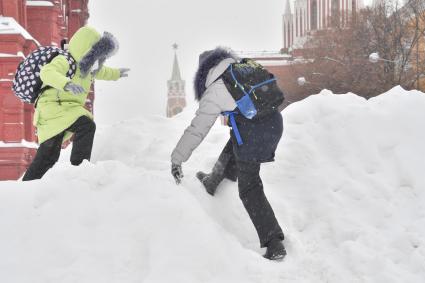 Москва. Дети играют на снежной горке в Кремлевском проезде.