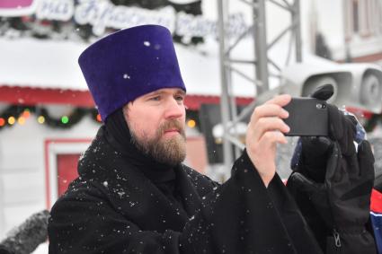 Москва. Отец Даниил Зубов     во время гала-матча по хоккею с мячом между сборными командами артистов театра и кино `Комар` и Ассоциации любительского хоккея `А-линия`на ГУМ-катке на Красной площади в рамках финального этапа   турнира на приз  Святейшего Патриарха Московского и всея Руси .