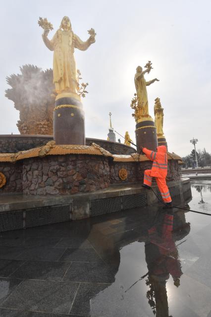 Москва. Работник `Гормоста` проводит промывку фонтана `Дружба народов` на ВДНХ.