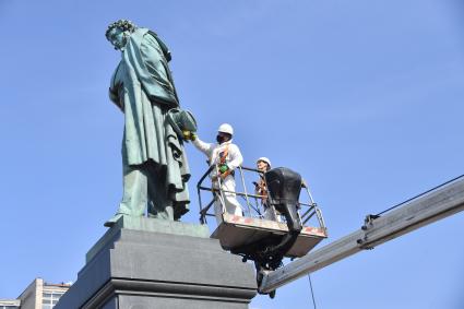 Москва. Сотрудник коммунальной службы во время промывки памятника Александру Пушкину на Пушкинской площади.