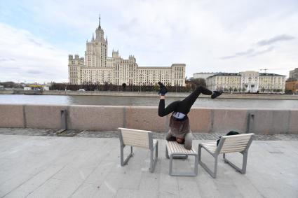 Москва. Девушка занимается йогой на Космодамианской набережной.