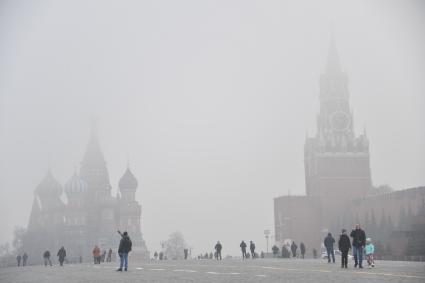 Москва. Прохожие на Красной площади  во время сильного тумана в городе.