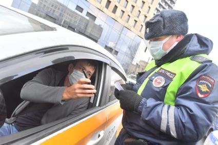 Москва.  Сотрудник ДПС на одной из улиц в Москве во время рейда по проверке соблюдения водителями такси санитарно-эпидемиологических требований.