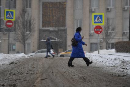 Москва.  Девушка идет по заснеженной улице.