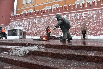 Москва.  Сотрудник коммунальной службы убирается возле Могилы Неизвестного Солдата  в Александровском саду.