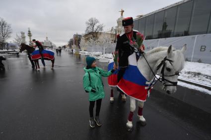 Москва. 8 марта. Всадники Кремлевской школы верховой езды дарят цветы посетительницам ВДНХ на площади Промышленности.