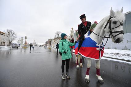 Москва. 8 марта. Всадники Кремлевской школы верховой езды дарят цветы посетительницам ВДНХ на площади Промышленности.