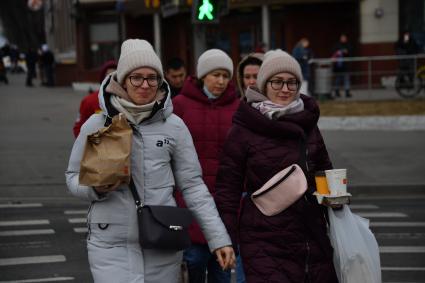 Москва. Девушки с пакетом из ресторана Макдональдс на Тверской улице накануне его закрытия. Рестораны быстрого питания `Макдональдс приостановливают работу в России из-за военной спецоперации РФ на Украине.