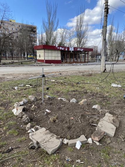 Украина. г.Мариуполь. Местные жители хоронят своих близких в городе. Могила на газоне Бульвара Шевченко.