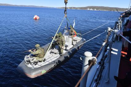 Североморск. Военнослужащие морской пехоты ВМФ РФ спускаются на воду в моторной лодке  с борта тяжёлого атомного ракетного крейсера  Петр Великий во время учений .