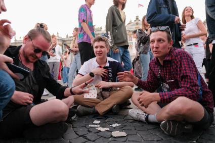 Санкт-Петербург.  Молодые люди на Дворцовой площади перед началом праздника  выпускников`Алые паруса`.