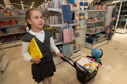 Санкт-Петербург. Девочка в отделе школьных принадлежностей в магазине канцтоваров `Буквоед` перед началом учебного года.