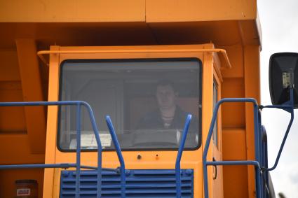 Жодино. Белоруссия. Водитель в кабине большегрузного самосвала Белорусского автомобильного завода (БелАЗ) - БелАЗ 75711.