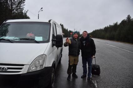 Новгородская  область.   Корреспондент  `Комсомольской правды` Владимир Ворсобин на дороге с водителем попутной машины.