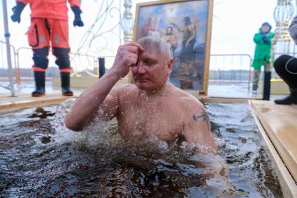 Санкт-Петербург.  Мужчина во время празднования Крещения у стен Петропавловской крепости.