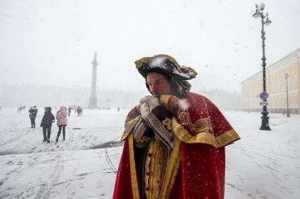 Санкт-Петербург. Мужчина в историческом костюме Петра I на Дворцовой площади во время снежного шторма.