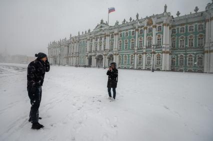 Санкт-Петербург. Прохожие на Дворцовой площади во время снежного шторма.