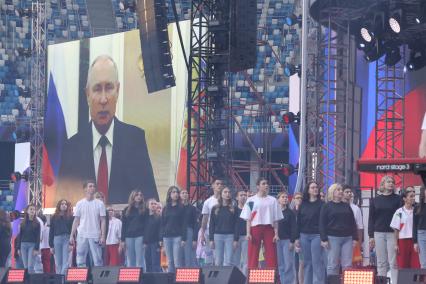 Нижний Новгород.  Участники  праздника слушают выступление президента России Владимира Путина на дне Молодежи.