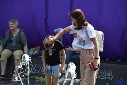 Москва. Женщина с девочкой у танцующих фонтанах в парке Музеон.