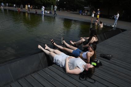 Москва. Девушки загорают у фонтана в Парке Горького.