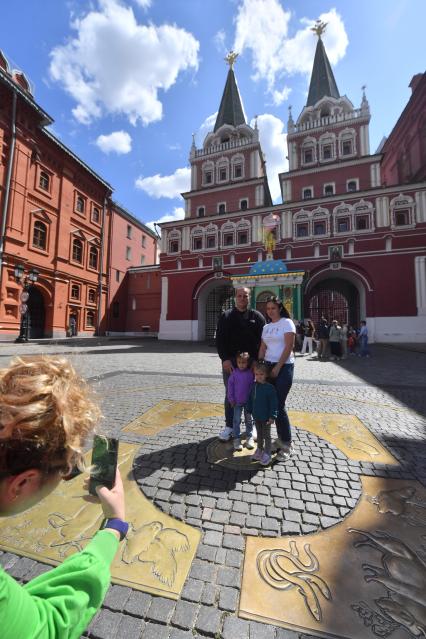 Москва. Люди фотографируются на Нулевом километре всех дорог России  на Манежной площади, у Воскресенских ворот и  Иверской часовни.