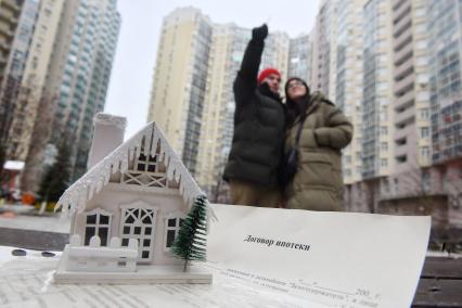 Екатеринбург. Молодая пара во дворе многоквартирного жилого дома, в котором они купили жилье в ипотеку